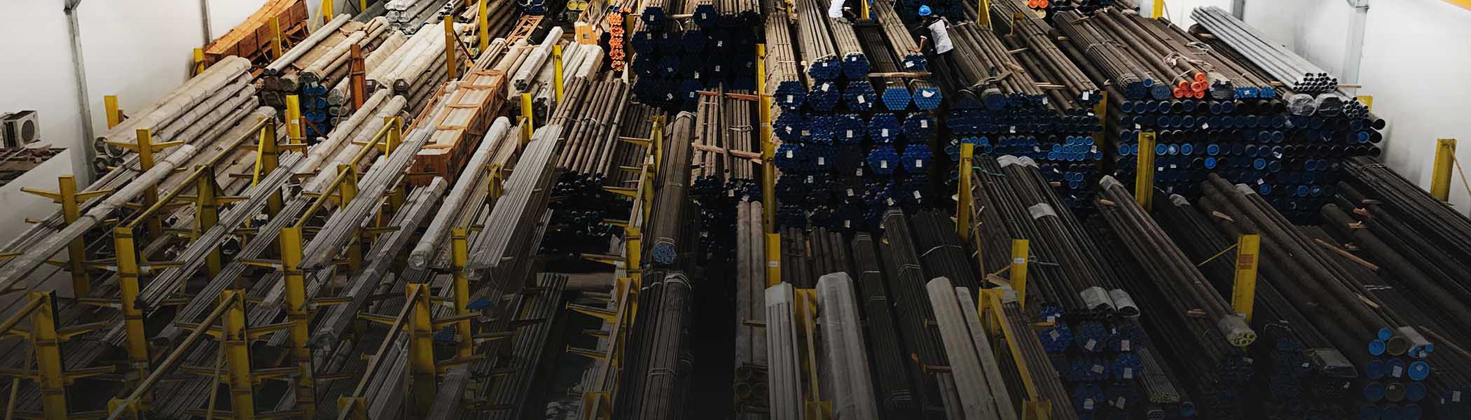 Organized steel piping inventory inside an industrial warehouse